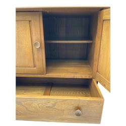 Ercol - elm and beech sideboard, fitted with cupboards and single drawer, enclosed by panelled doors, on splayed tapering feet