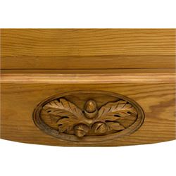 Pine chest of drawers topped with carved pediment with acorn and oak leaf motif, fitted with two short over three long drawers, standing on shaped apron base (W92, D46, H97cm); pine bedside cabinet, single drawer above paneled cupboard door enclosing open storage, shaped plinth base (W43, L32, H67cm)