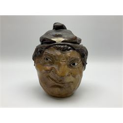 Rare early 20th century Martin Brothers stoneware tobacco jar and cover designed by Robert Wallace Martin, modelled in relief as a smirking face to one side, the other side modelled as the same subject wearing a quizzical expression, the cover formed as a sack hat, incised marks to base 'R W. Martin London & Southall. 10.1.1910', and to inner rim of cover 'R. W. Martin. & Bros London & Southall. 10.1.1910', H18cm

Cf. Waddington's Canada Lot 51 A Private Collection of Martin Brothers Stoneware 06/12/2017
Woolley & Wallace Lot 37 British Art Pottery 01/12/2010