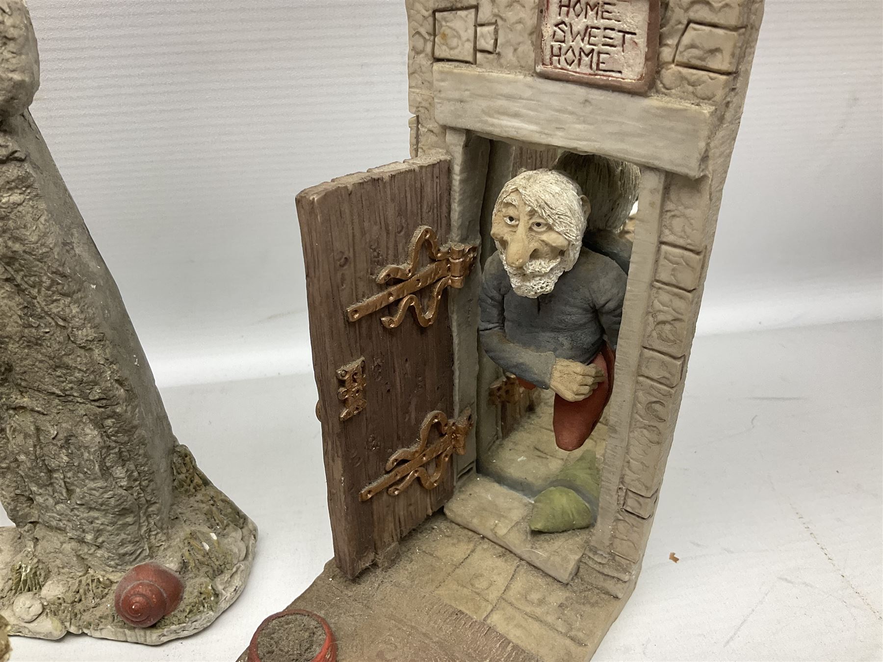 Seven Terry Pratchett Discworld figures by Clarecraft, to include The Luggage DW04M Smugli D990, pair of Home Sweet Home bookends, wall hanging modelled as a dragon upon stone plinth etc, tallest H19cm