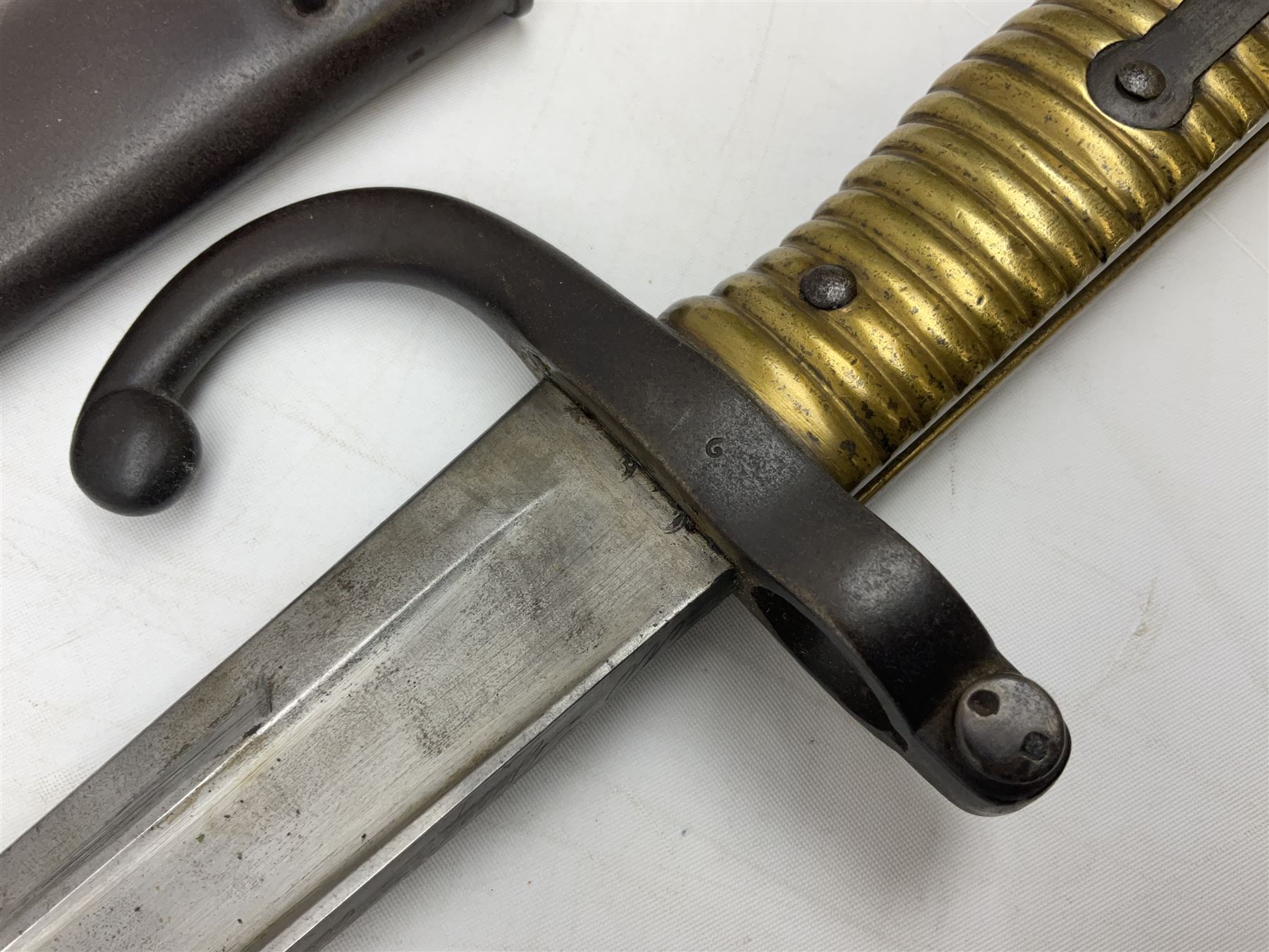 French model 1866 sabre bayonet, the 57.5cm curving blade marked St. Etienne 1868; in associated steel scabbard L71cm overall