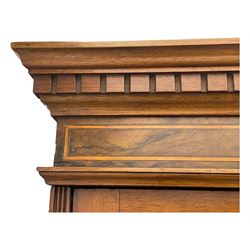 Late Victorian walnut triple combination wardrobe, projecting moulded and dentil cornice, central shaped bevelled mirror glazed door, cartouche and curled leaf carved panels over figured walnut veneered panels, fitted with drawer to base, on bracket feet