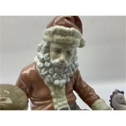 Lladro figure, A Special Toy, modelled as Father Christmas with a young boy, with original box, no 5971, year issued 1993, year retired 1996, H26cm