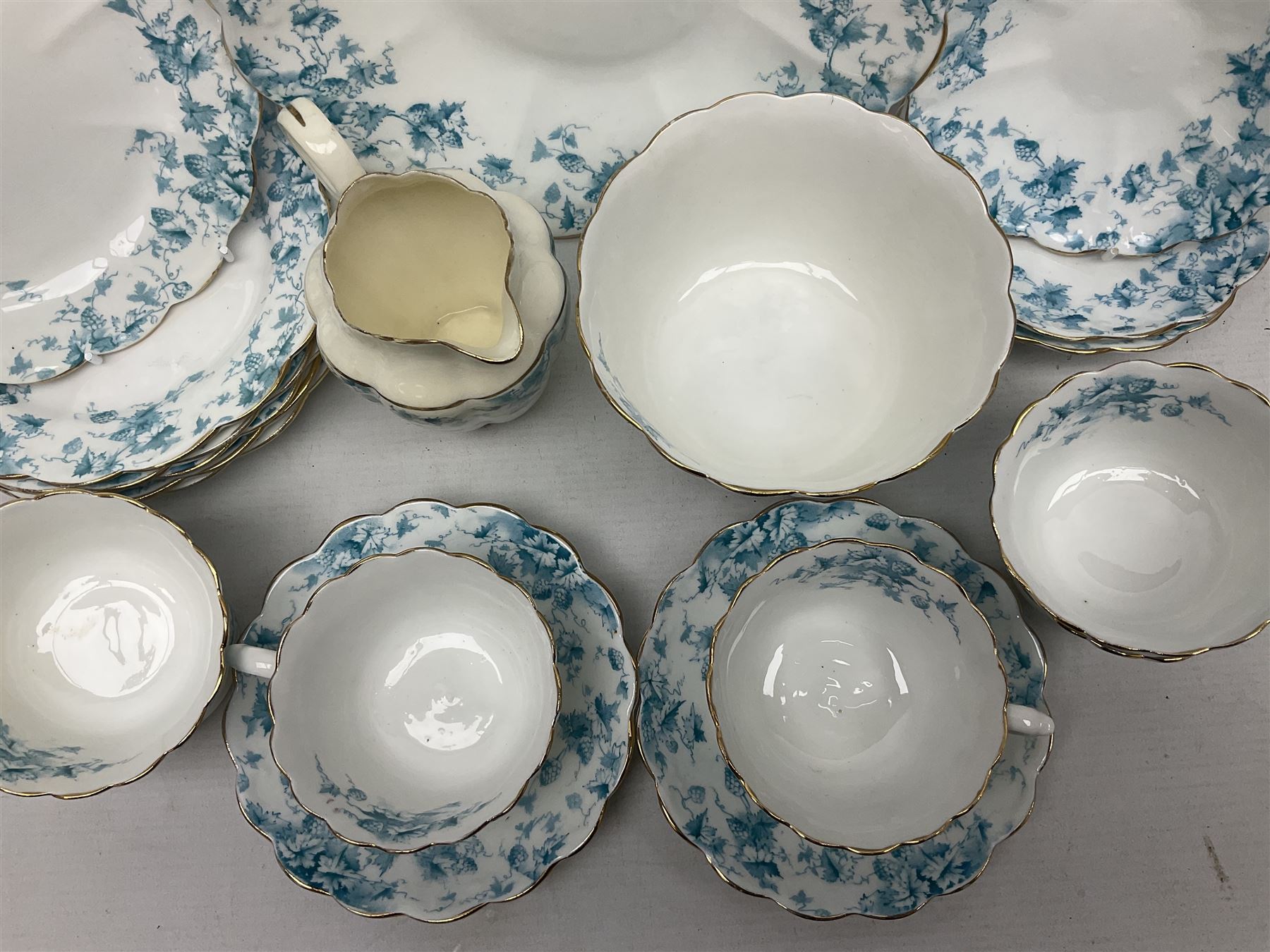 Edwardian David Chapman & Sons tea service for six, of lobed form decorated with blue transfer printed foliate decoration and gilt rims