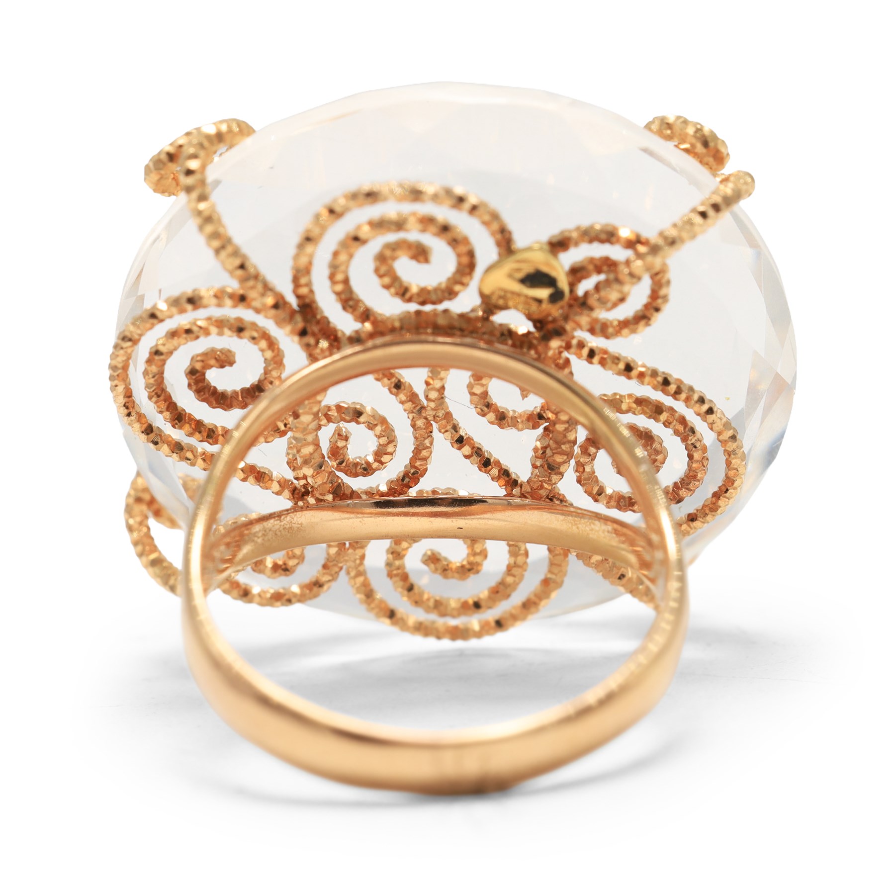 18ct gold rock crystal ring, single round cut crystal, mounted in a fancy textured swirl under setting, stamped 750