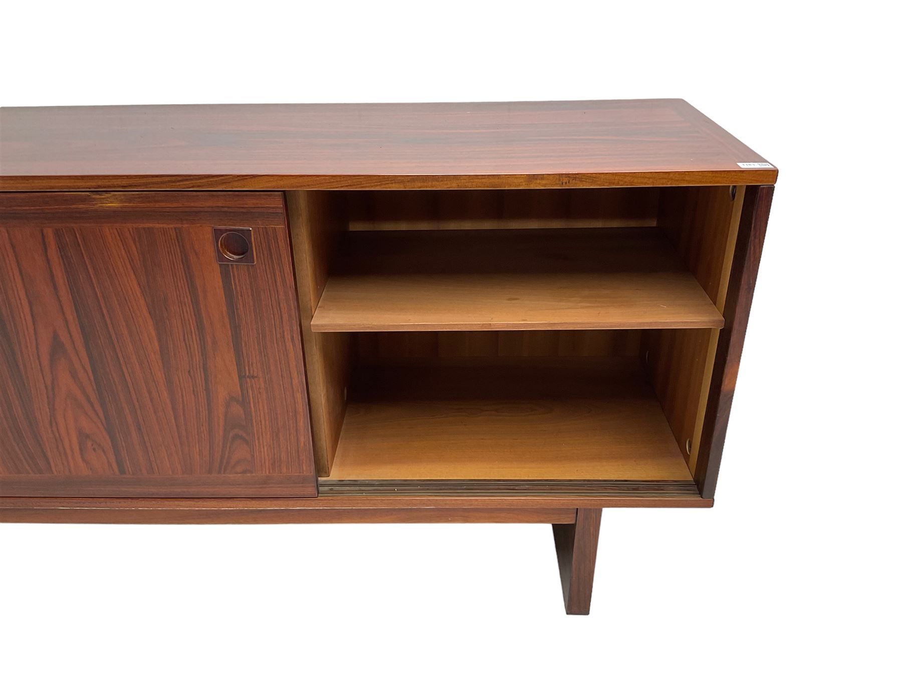 NH Chapman & Co Siesta - mid-20th century sideboard, fitted with three sliding doors, enclosing two drawers and shelves, raised on twin end supports