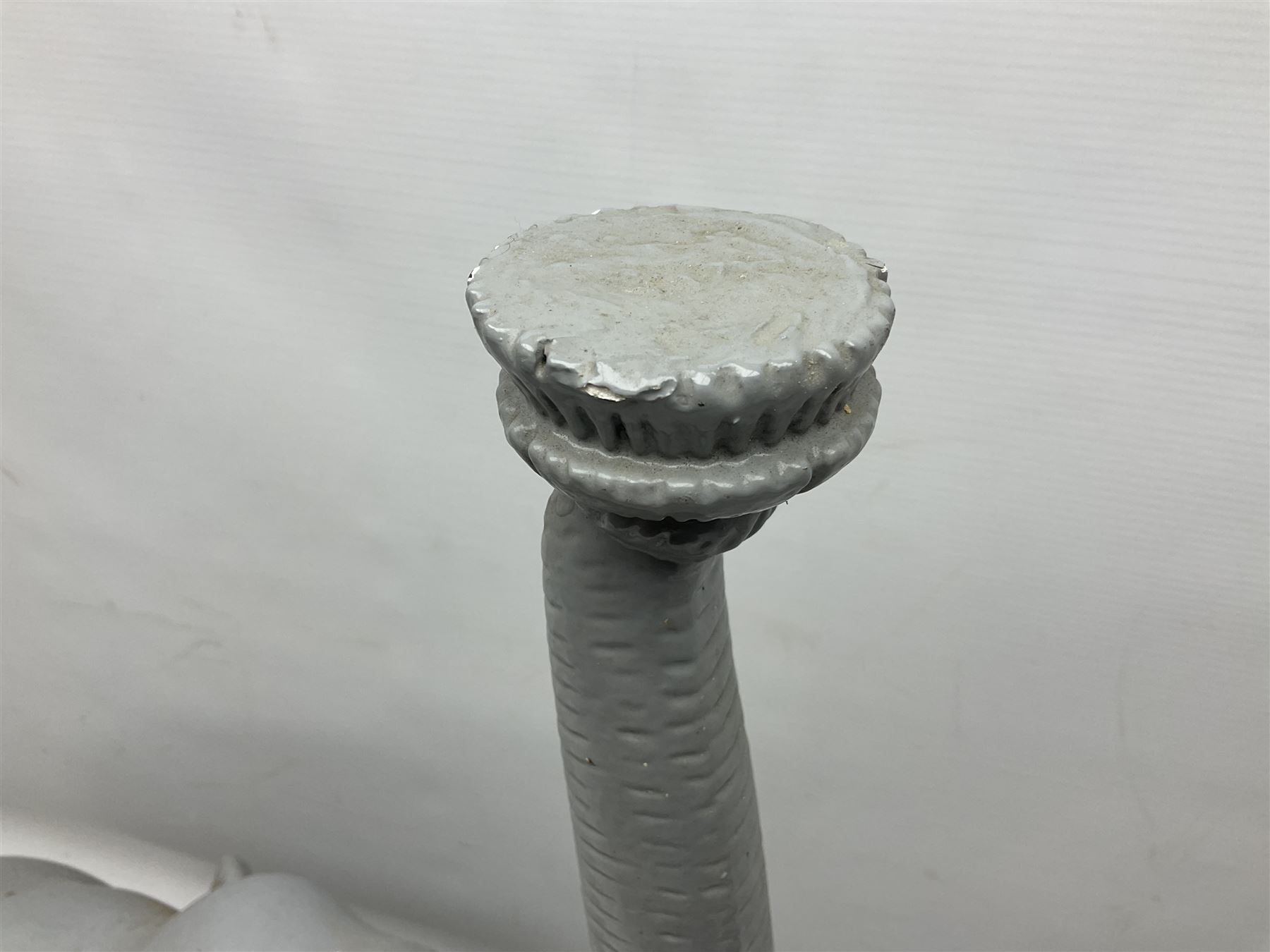 Composite figure of an elephant, painted grey, upon white base, L45cm H65cm