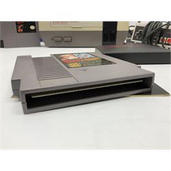 Nintendo Entertainment System (1985) console with two controllers, accessories and instruction booklet. NES Games ‘Duck Hunt’ with Nintendo Zapper gun, ‘Pinball’ and ‘Super Mario Bros.’, all with original sleeves and instruction booklets. NES game ‘Super Mario Bros. 2’ cartridge only