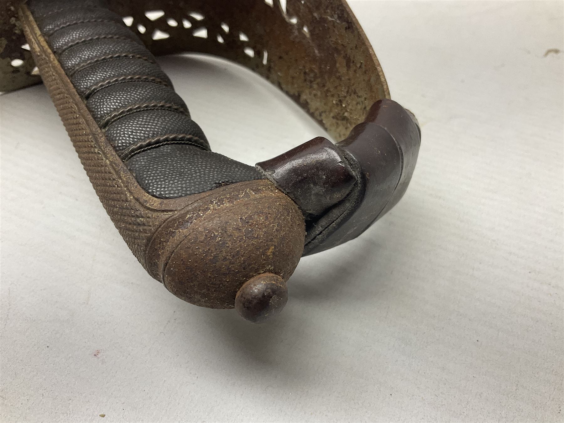 George V 1897 pattern Army Officer's sword by Henry Wilkinson Pall Mall London, the 82.5cm 'London Made' blade etched to both sides with Royal Crests and cyphers etc, pierced half-basket hilt with wire-bound fish skin grip and remains of leather knot strap; in leather covered field service scabbard L101cm overall; and two 14th Prince of Wales Own swagger sticks (3)