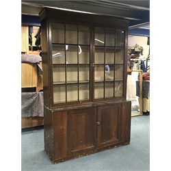 Early 19th century stained pine bookcase on cupboard, fitted with two astragal glazed doors above two cupboards, W153cm, D49cm, H321cm