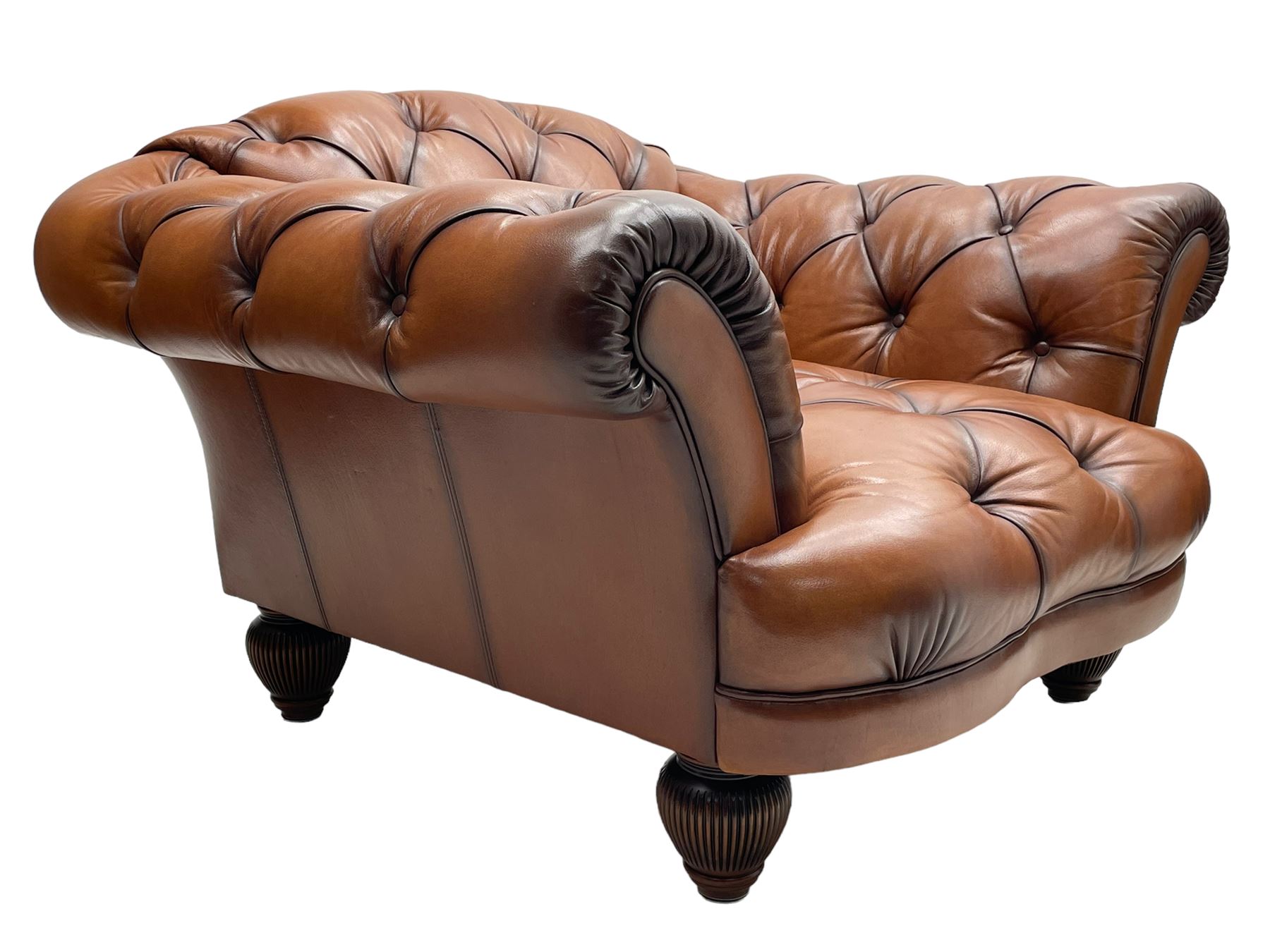 Tetrad - 'Oskar' armchair, Chesterfield shape with rolled arms, upholstered in buttoned tan leather, on turned and reed moulded feet 