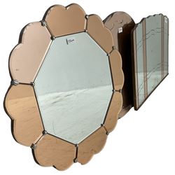 Early 20th century frameless wall mirror with copper-tainted glass (76cm x 51cm); circular frameless mirror (D56cm); and another flower head shaped frameless mirror (D61cm)