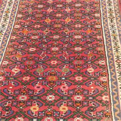 North West Persian runner, red field decorated with repeating herati motifs and small flowerheads, enclosed by cream main border with stylised floral motifs and narrow guard borders, fringed ends