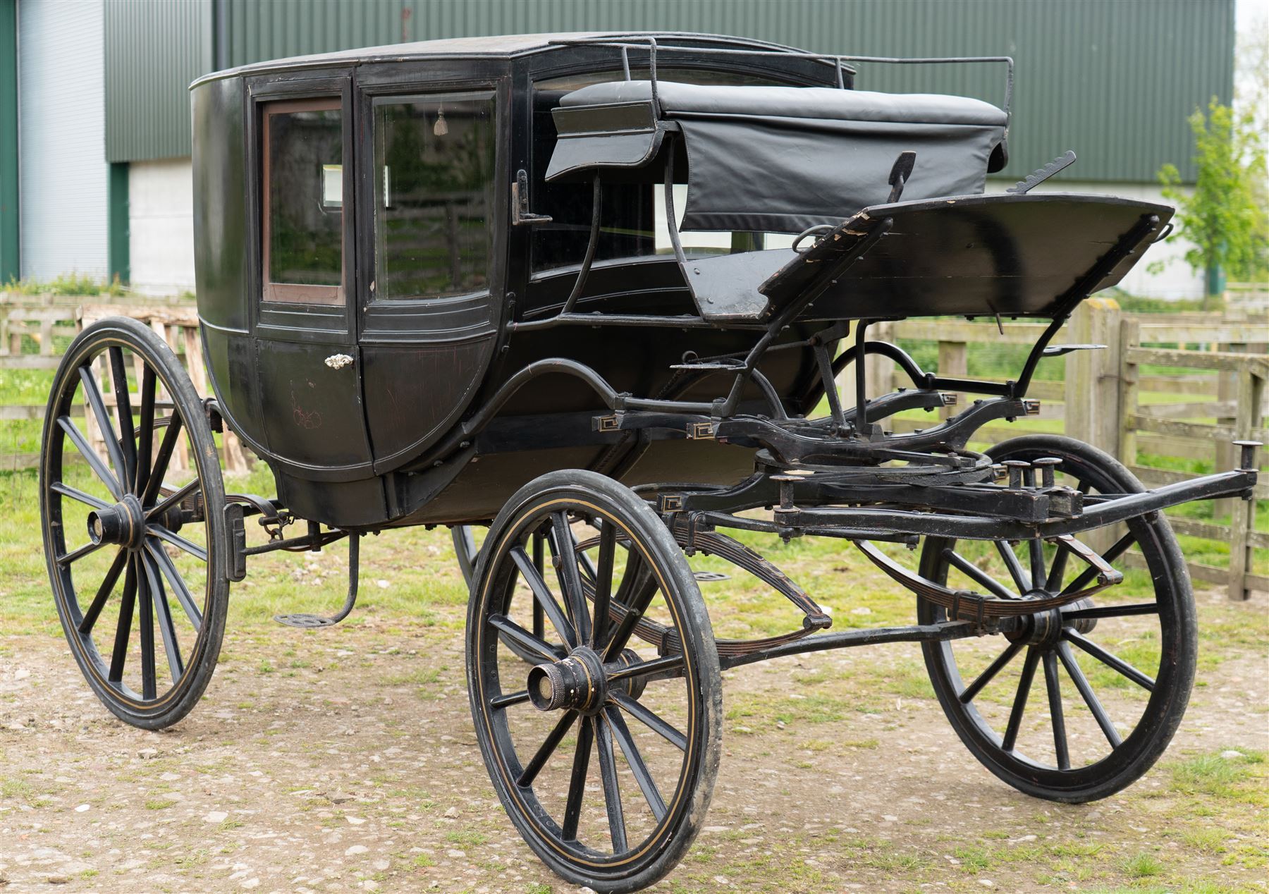 Town Coach by John Marstons Birmingham - Ex Film

A black painted five glass Town Coach by John Marston's Carriage Works Ltd, Birmingham, with enclosed glazed passenger compartment, curved front glass, external coachman's box seat and pole for driving with a pair of horses. The carriage has a timber coach body with buttoned black leather interior, blue upholstered seat cushions, plated exterior door handle, maker plates to the body and step, and John Marston marked hub caps. Mounted on black painted wooden spoked wheels with rubber tyres, leaf spring suspension, underbody turntable steering and iron fittings throughout.
Featured on the film set of 'Victoria' with Jenna Coleman

Features

• Black painted enclosed coach body
• Glazed passenger compartment with five windows
• Curved front glass
• Buttoned black leather interior
• Blue upholstered seat cushions
• External coachman's box seat
• Timber coach body
• Wooden spoked wheels
• Rubber tyres
• Leaf spring suspension
• Underbody turntable steering
• Pole for pair of horses
• Iron foot steps
• Plated exterior door handle
• Maker plates for John Marston's Carriage Works Ltd, Birmingham
• John Marston marked hub caps
• Featured on the film set of Victoria with Jenna Coleman

Dimensions:
Overall length: 390 cm
Width: 190 cm
Height: 214 cm

Wheel Diameters:
Front wheels: 104 cm
Rear wheels: 134 cm

Seating:
Coachman's box: 2
Passenger compartment: 4