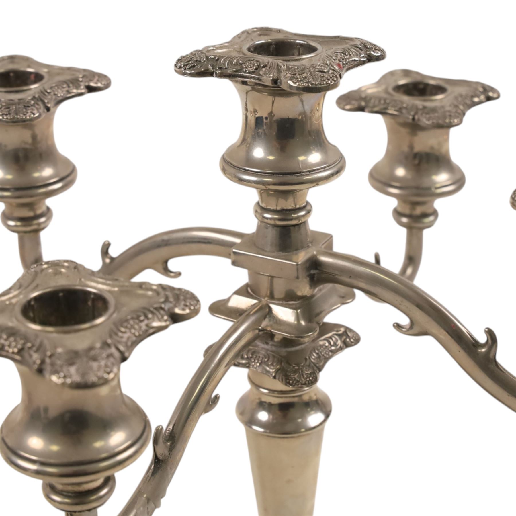 Silver plate two branch candelabra with grape vine decoration to the base, together with a matching pair of candle sticks and other candlesticks  