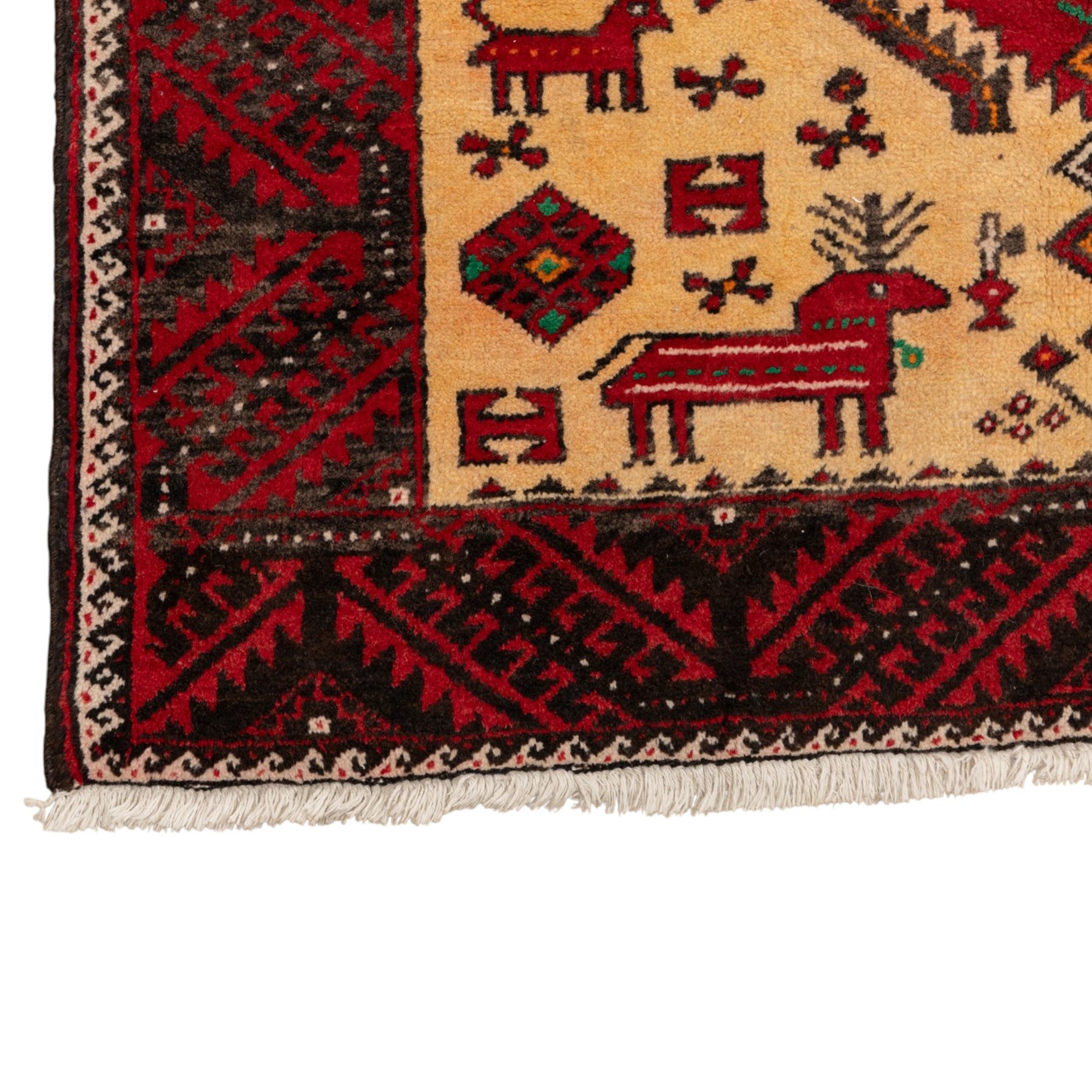 North East Persian Meshed Baluch rug, the ivory field decorated with two stepped diamond medallions and angular red motifs, interspersed with stylised horned animals, birds, flowerheads and geometric devices, enclosed by a dark brown border of repeating red serrated leaves and narrow ivory guard bands