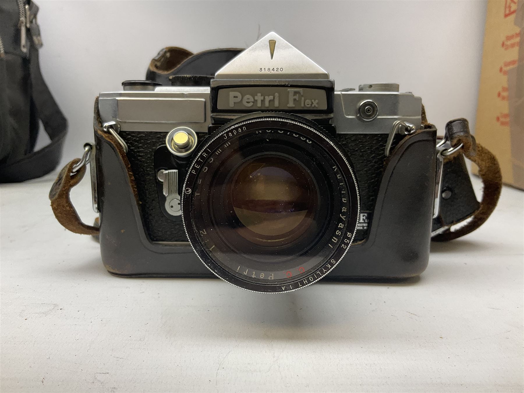 Petri FT 35mm SLR camera with a Petri 1:1.8 55mm lens, Petri Flex camera with a Petri 1:2 55mm Kuribayashi lens, together with cases and quantity of lenses etc