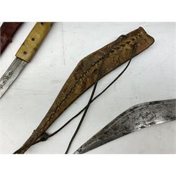 Near pair of African Moroccan Berber tribal Shula daggers each with engraved 39cm curving fullered steel blade, carved and inlaid horn grip and leather covered scabbard L57cm overall; kindjal style dagger with brass covered and jewelled grip and scabbard; another Eastern dagger with leather covered grip and scabbard; and a large Eastern knife with animal hide scabbard (5)
