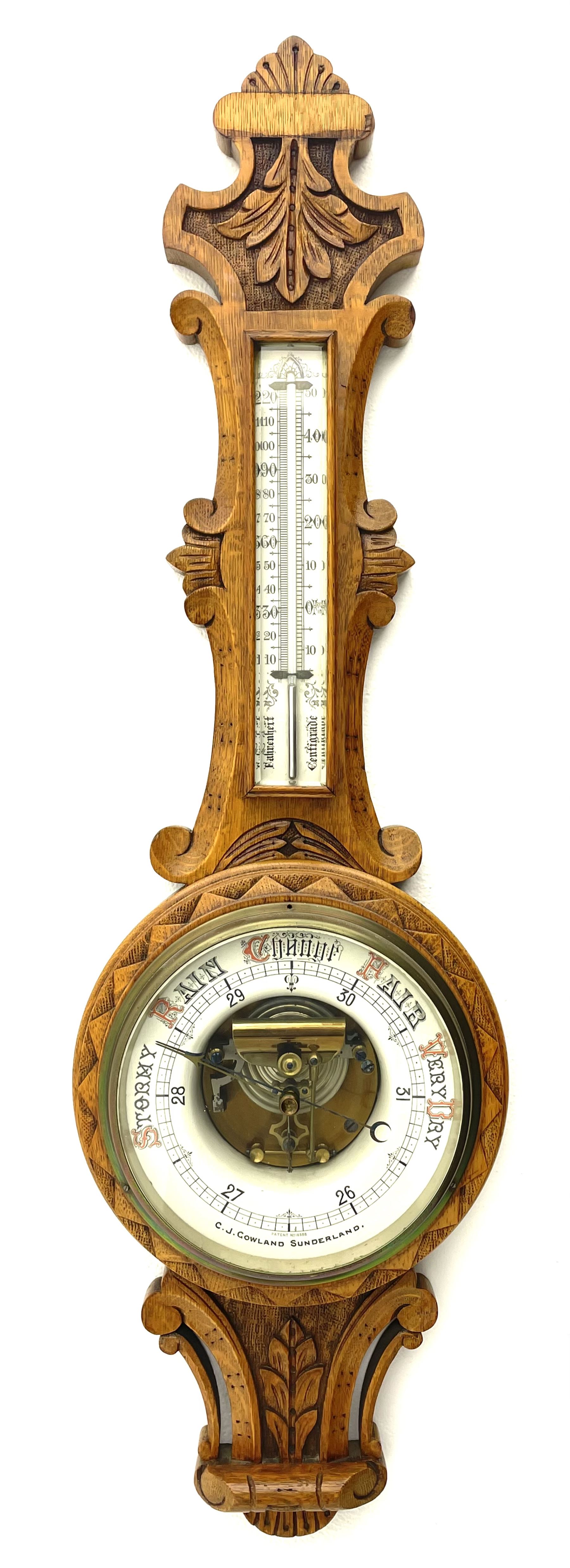 Early 20th century carved oak card aneroid barometer with visible aneroid and mercury thermometer, by ‘C. J. Gowland, Sunderland’ 