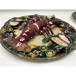 Two 20th Century Portuguese Palissy style Majolica wall plates, one depicting a crab, the other a lobster each to the centre modelled in relief surrounded by encrustations and shells, both with impress marks beneath, D32cm