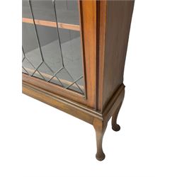 Early 20th century walnut display cabinet, projecting moulded cornice over two lead glazed doors, the interior fitted with three adjustable shelves, on cabriole supports