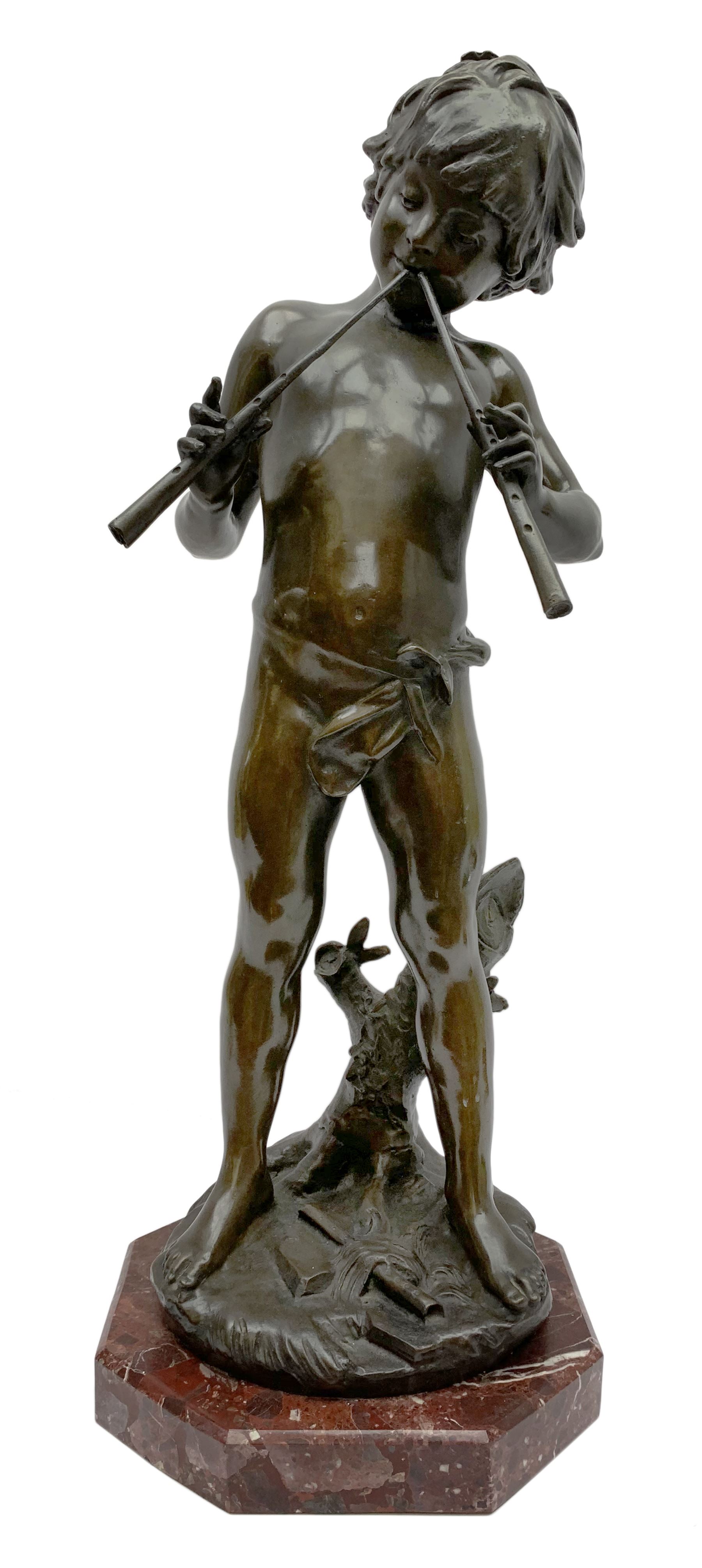 After Auguste Moreau (French 1834-1917): large bronze figure modelled as a young boy playing two pipes, standing upon a naturalistically modelled base detailed with tree stump and further pipe, signed Aug Moreau, upon octagonal red marble base, H72cm 