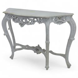 Early 20th-century Rococo revival-style console table, white serpentine-shaped marble top with moulded edge, frieze with openwork scrolling foliage, rocaille shells and deep apron, stretcher with central carved cartouche with shell and foliate motifs, supported on four cabriole legs, knees carved with acanthus leaf and terminating in scroll feet 