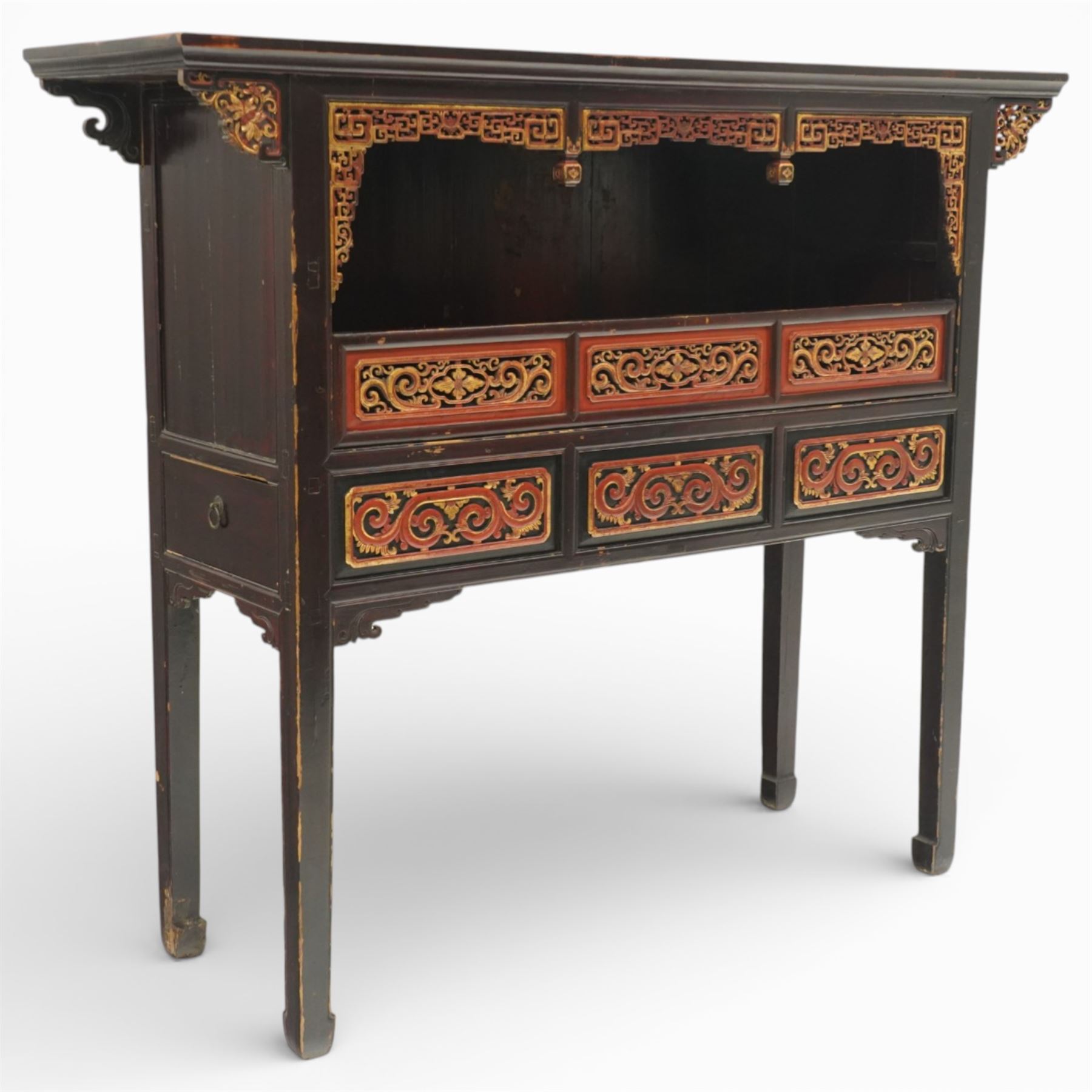 Chinese black lacquer Buddha cabinet, moulded top over open display recess framed by pierced geometric fretwork and corner spandrels, the base fitted with an arrangement of five drawers with carved and gilt scrollwork panels, on square supports with shaped apron brackets