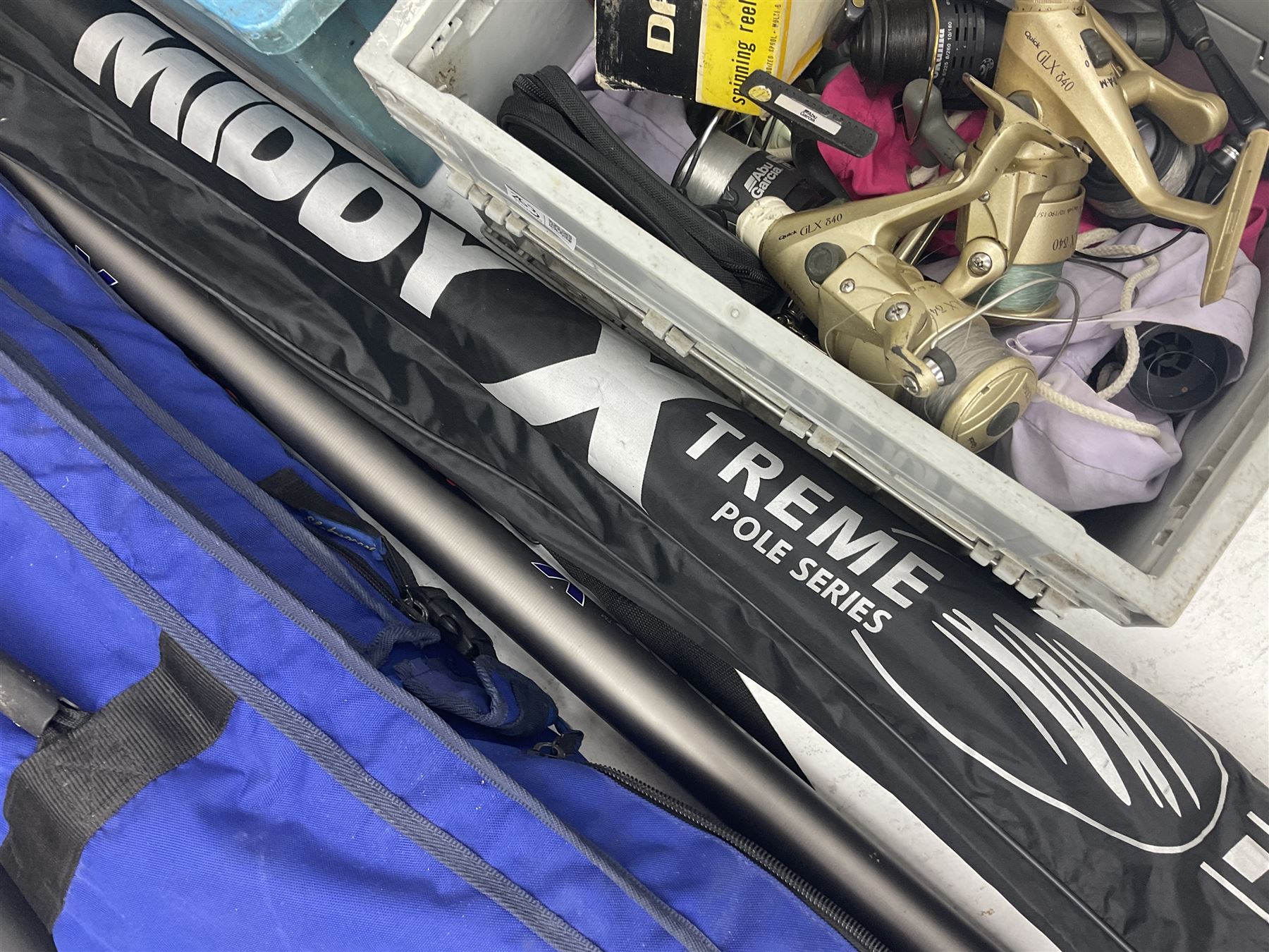 Fishing equipment, comprising reels to include Daiwa No.7300, boxed, Quick GLX 840, Quantum Heat BCS 350, okuma etc, together with various tackle, various poles, split canes and rods to include Middy Xtreme, Shakespeare Quo Carp, etc, many in bags