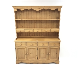  Solid pine Welsh dresser, projecting cornice, two plate racks above five short and four long drawers, four cupboards, shaped plinth base, W153cm, H187cm, D44cm  