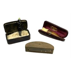 Victorian horn snuff box, containing a spun glass figure, together with a cased amber cheroot holder with meerschaum mount, and a vintage puzzle toy, (3)