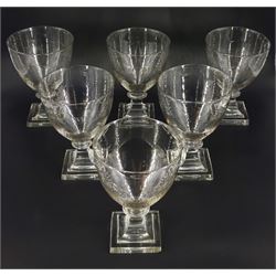 Set of six late 18th/early 19th century glass rummers, the bowls engraved with foliate swag beneath the inscription 'Loyal Mellor Volunteers', upon stepped square bases, H14cm, together with a decanter engraved 'Loyal Mellor Volunteers' to front, and 'Rum' with floral swag verso, H19.5cm