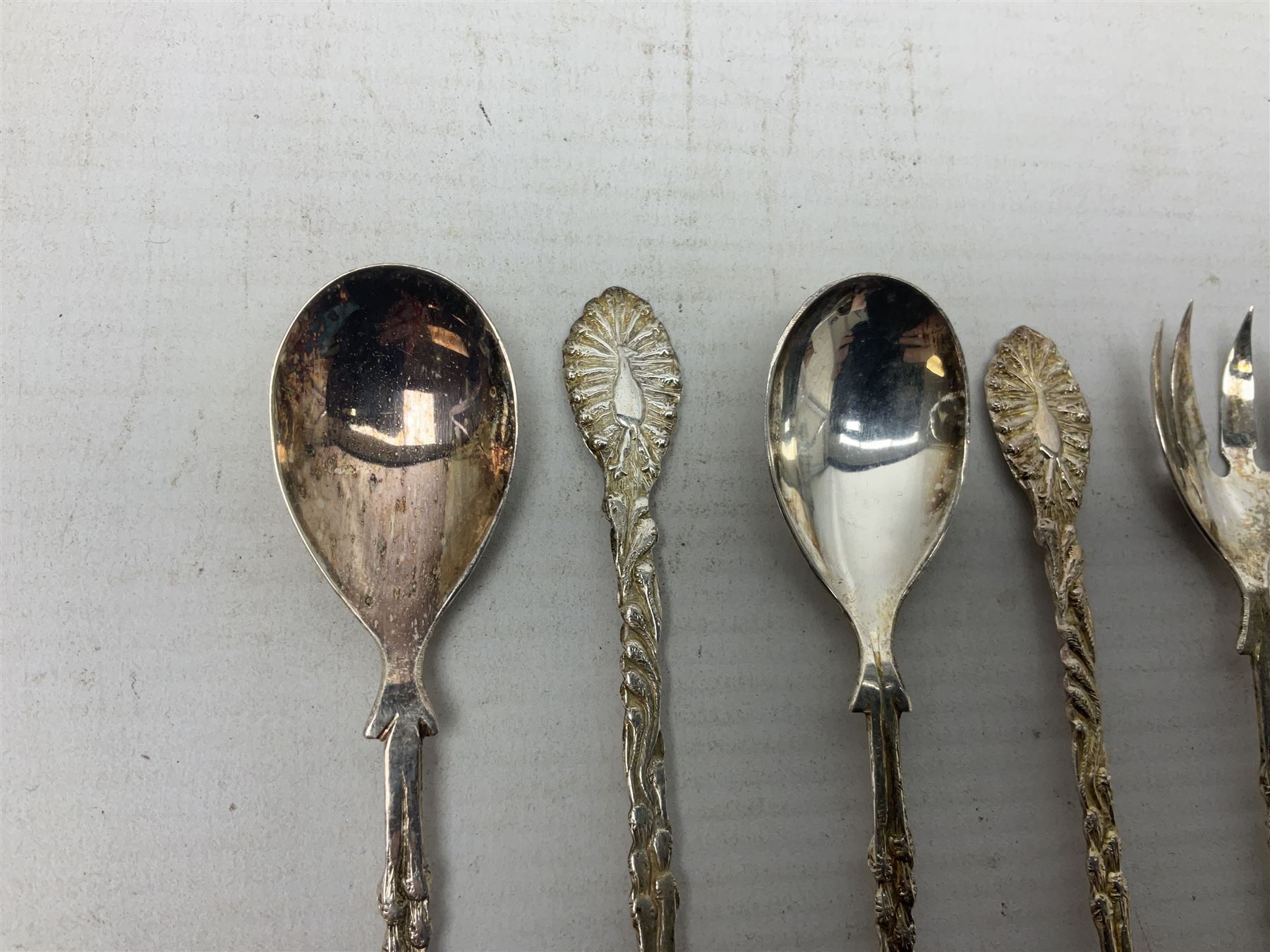 Set of four Continental silver spoons and forks, with stylised terminals, a number stamped S800, approximate weight 88.4 grams
