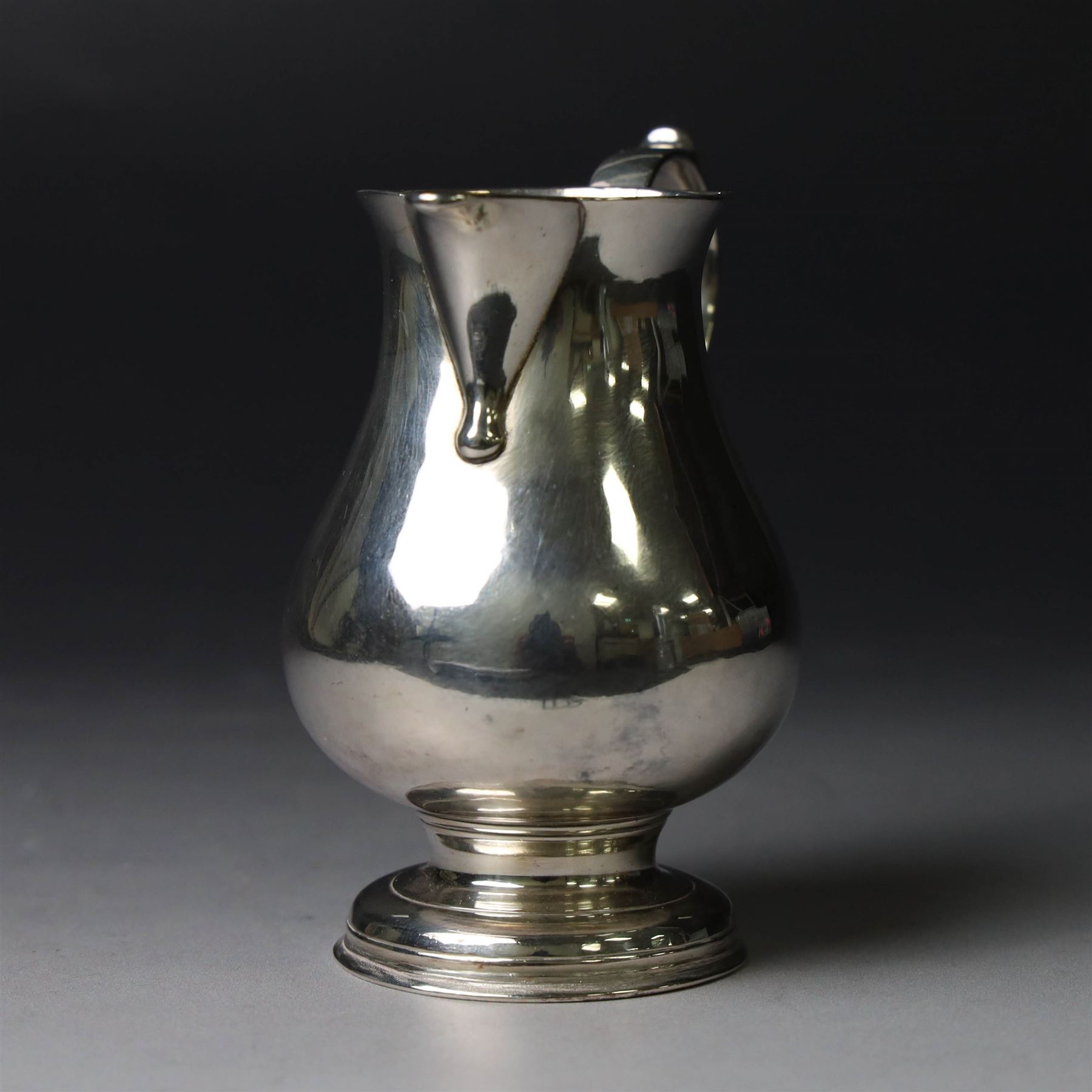 George II silver cream jug, of plain bellied form with capped scroll handle and sparrow beak, upon stepped circular foot, hallmarked London 1737, makers mark indistinct, H8.5cm
