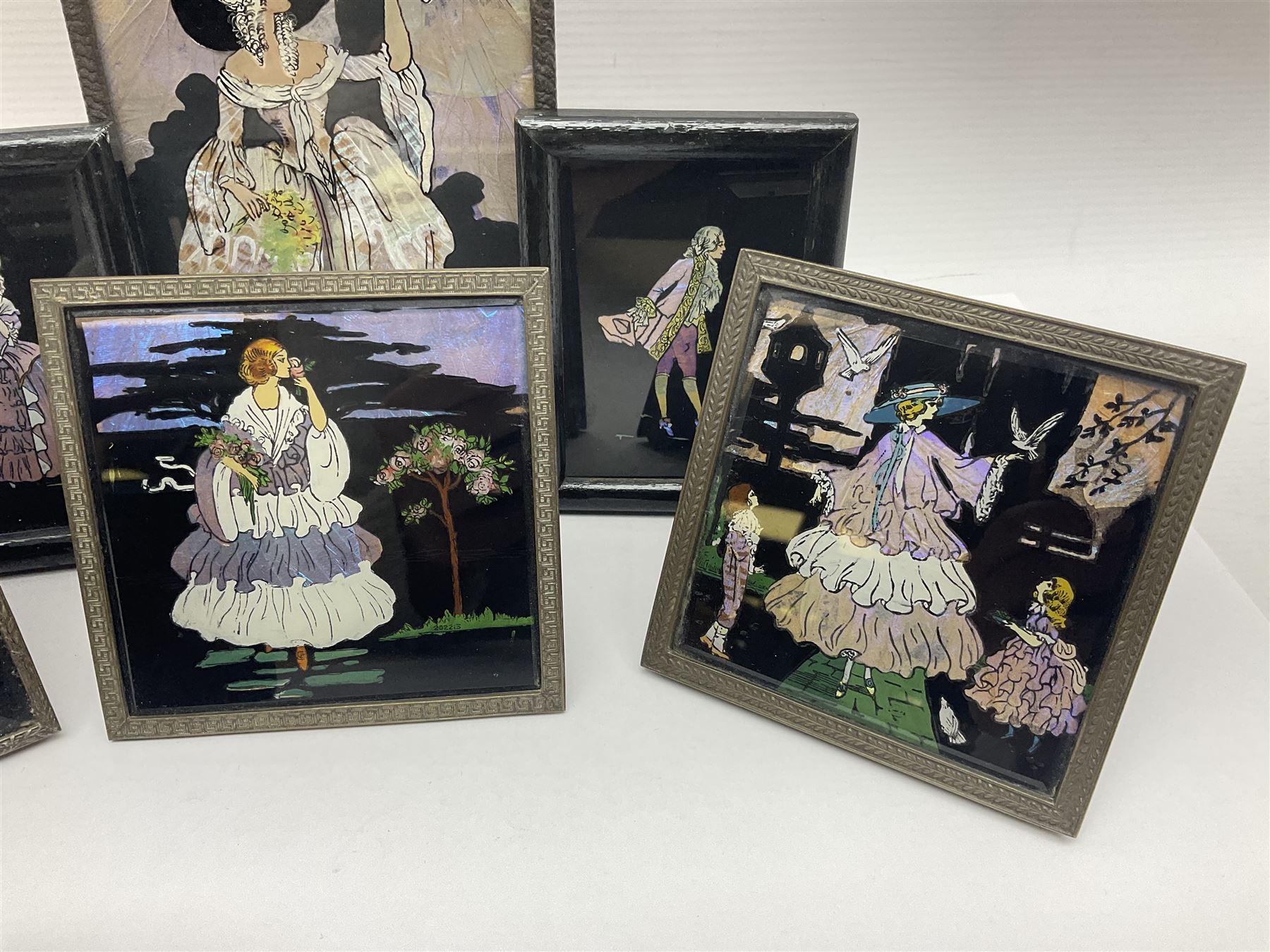 Seven 1930's butterfly wing pictures, mainly of ladies in period dress, one signed Dorothy Buckley, largest H18cm