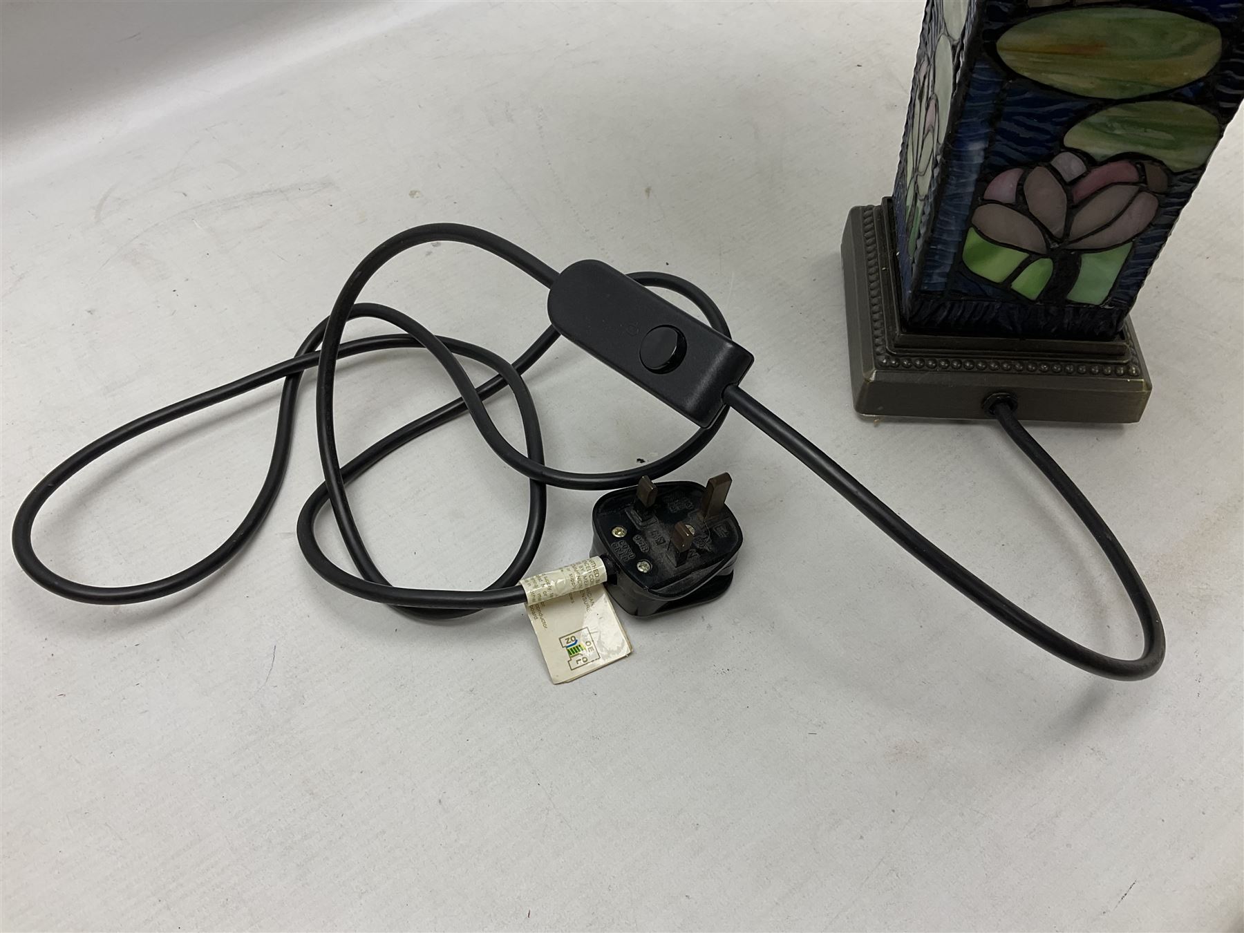 Tiffany Pond Lily style table lamp and shade with leaded panels of green, pink and rippled blue water effect ground, raised upon brushed metal base, H50cm