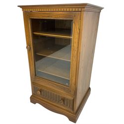 Ercol - mid-20th century dark elm 'Old Colonial' music cabinet, single glazed door enclosing three shelves, single drawer fitted to base