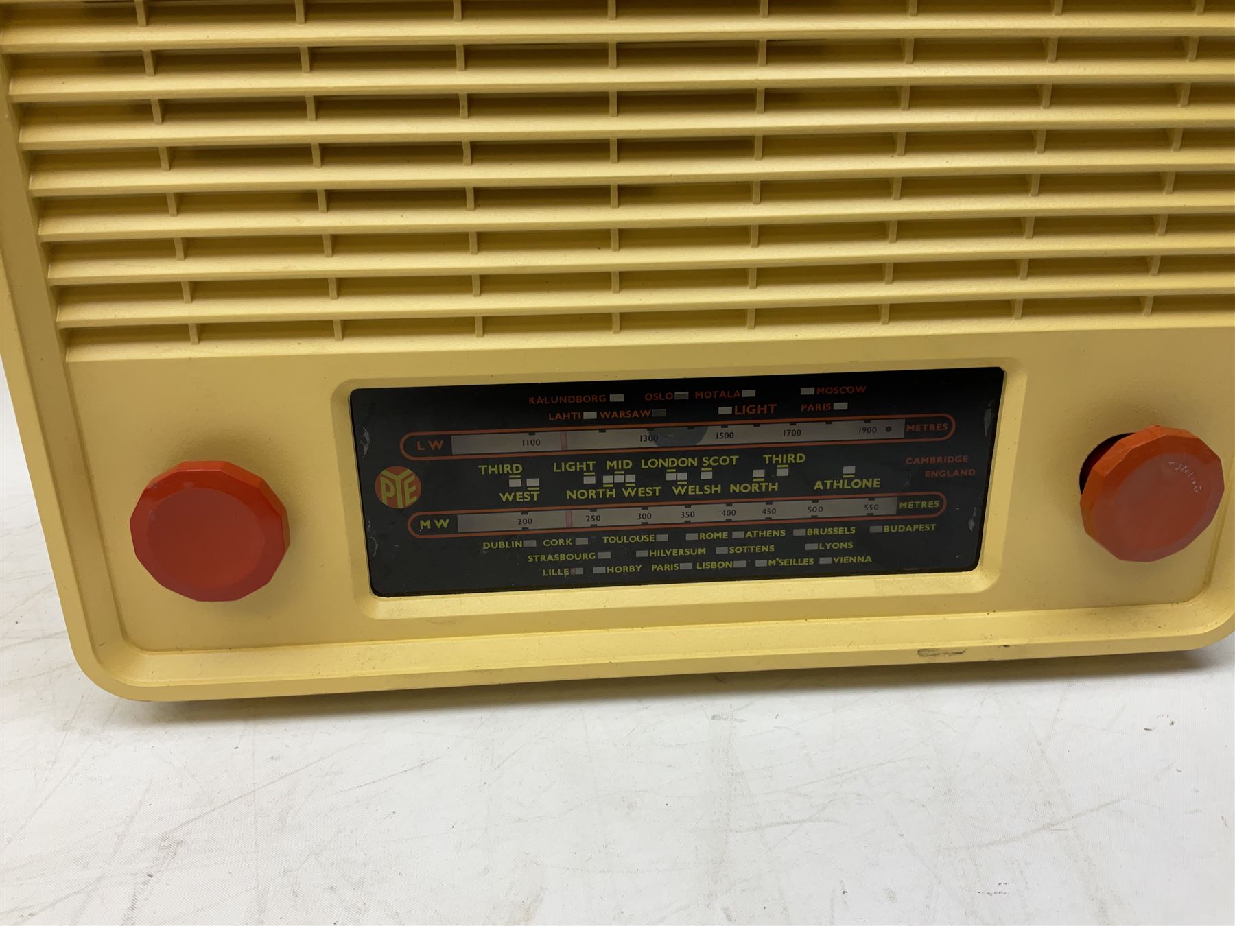 1950s Pye Type P43 cabinet radio in cream Bakelite case with orange knobs, W30cm H22cm D16cm, together with Ever Ready Sky Queen portable radio, Ekco portable radio in red case, Boxed Bush Special Edition 2002 Queens Golden Jubilee radio, Hacker Herald VHS radio (5)