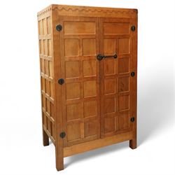 Mouseman - Oak 5' x 3' wardrobe, circa 1950s, scalloped cornice, panelled sides and front, twin doors with wrought metal latch and hinges, raised on stile supports with carved mouse to left hand side, by the workshop of Robert Thompson, Kilburn

Provenance - this lot comes to us for sale from direct descent of Robert Thompson. Thompson is the great grandfather of the vendor.
