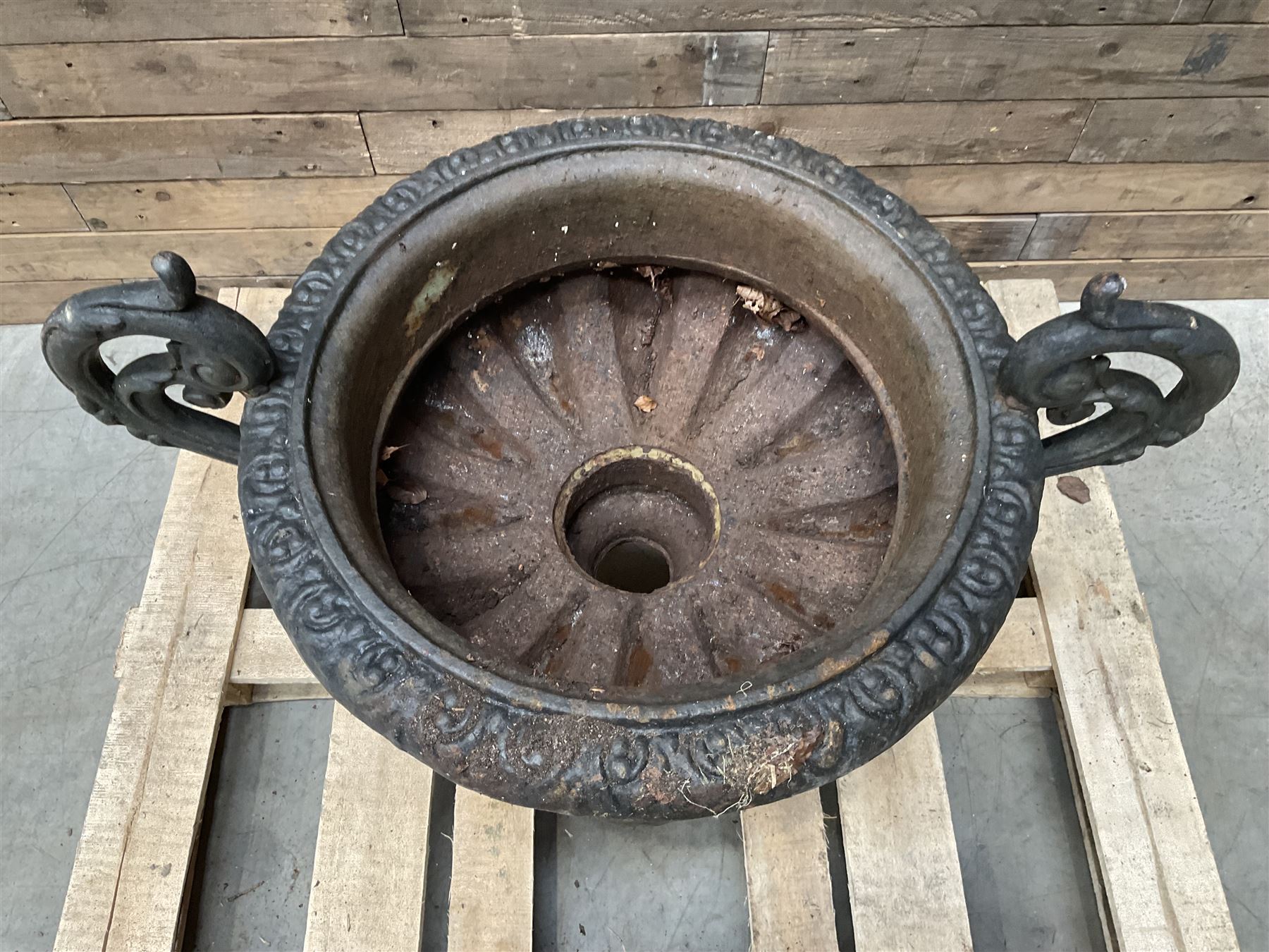 Victorian design ornate cast iron centrepiece urn, featuring two handles, raised on footed base