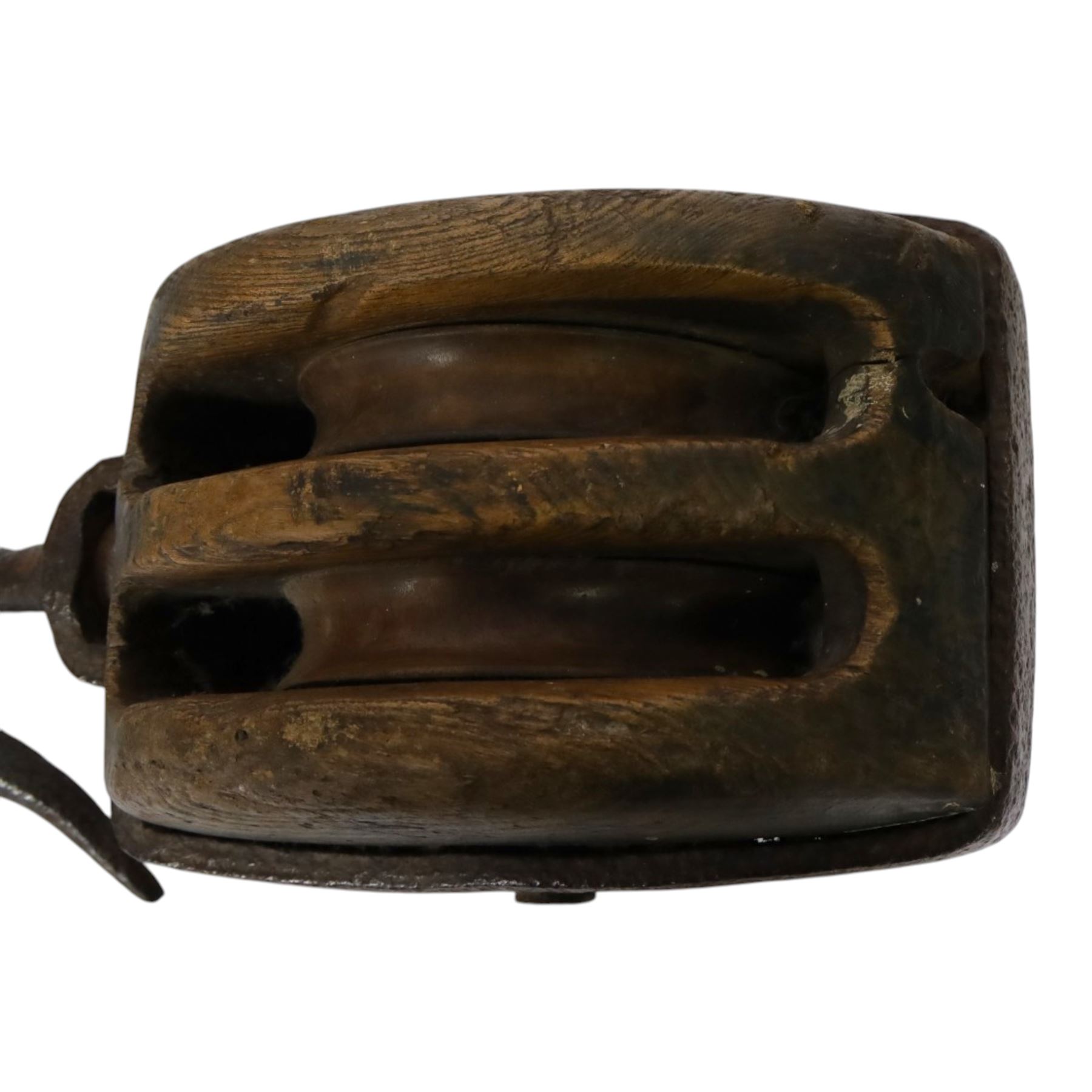 19th century double-sheave wooden pulley block in a metal casing, fitted with an iron hook, stamped GIS to one side, including hook L36cm