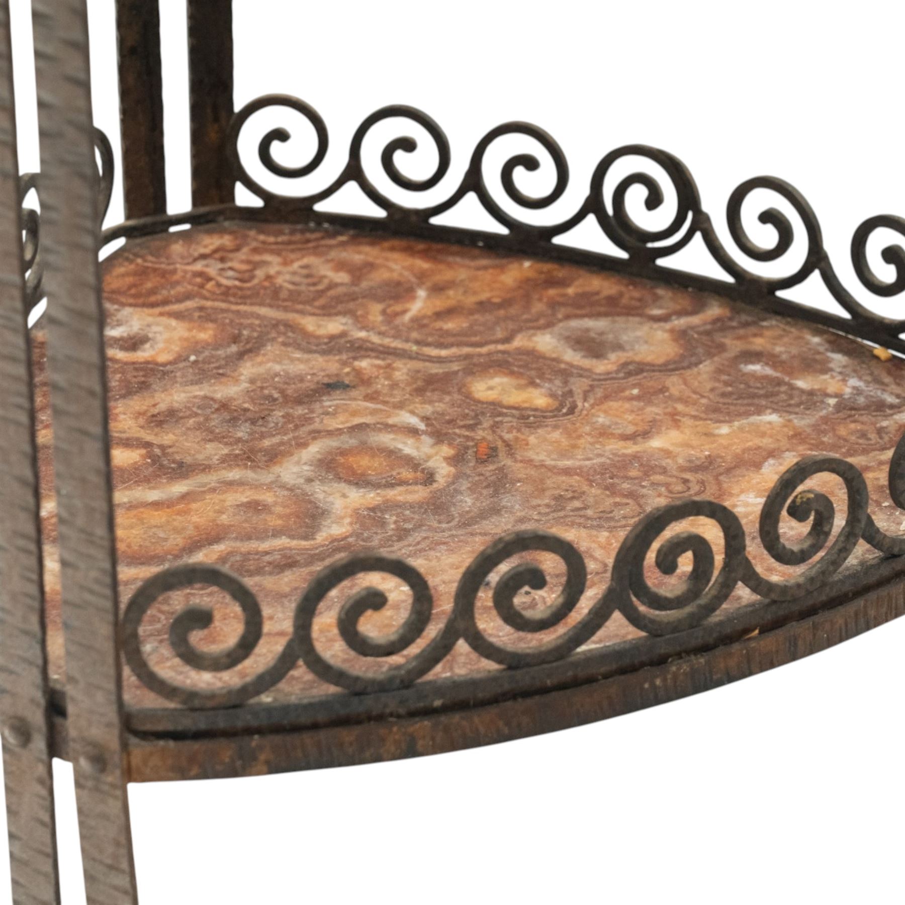 Art Nouveau wrought metal and specimen marble two-tier occasional table, the triangular marble top raised on strap metal uprights with scroll capitals, the under-tier with raised Vitruvian scroll design gallery