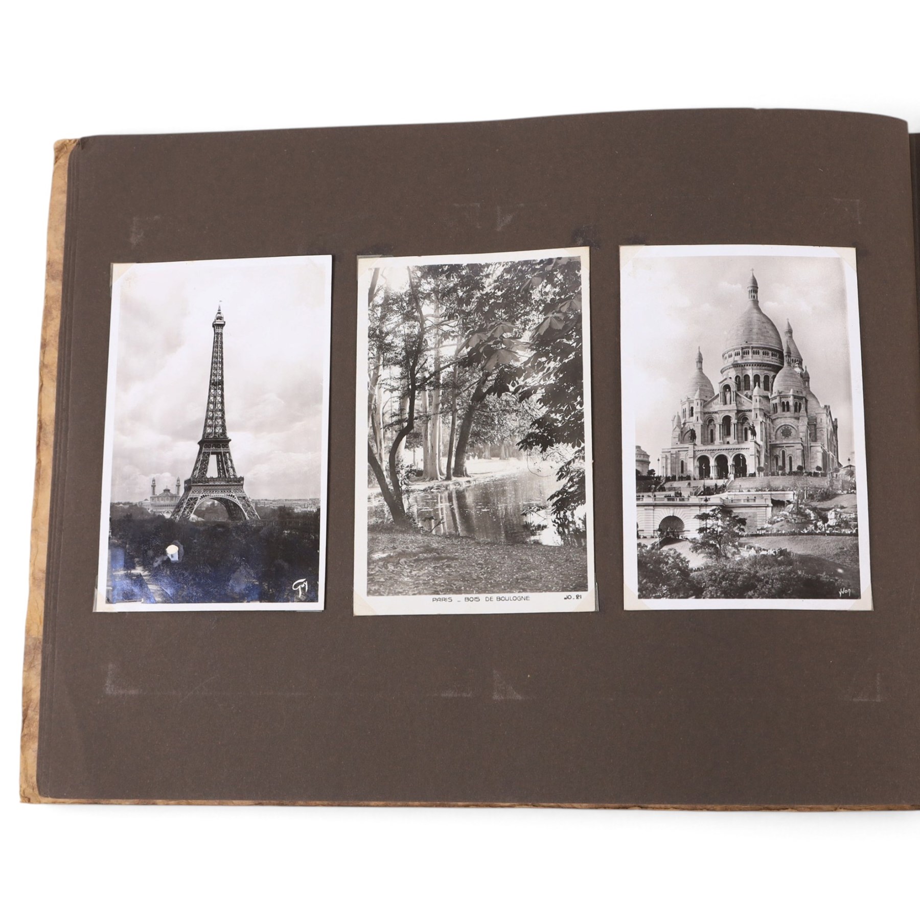 Two early to mid 20th century postcard albums, containing black and white and colour postcards of France, Turkey and Egypt, together with some personal photographs and newspaper clippings