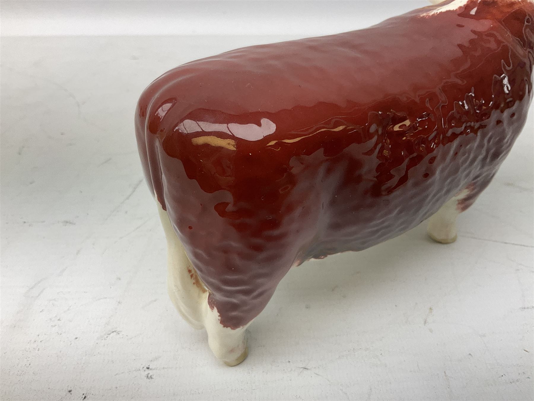 Three Beswick models comprising Hereford Bull no 949, 'CH Cutmil Cupie' Pug, and bay Shire horse, all with printed marks beneath