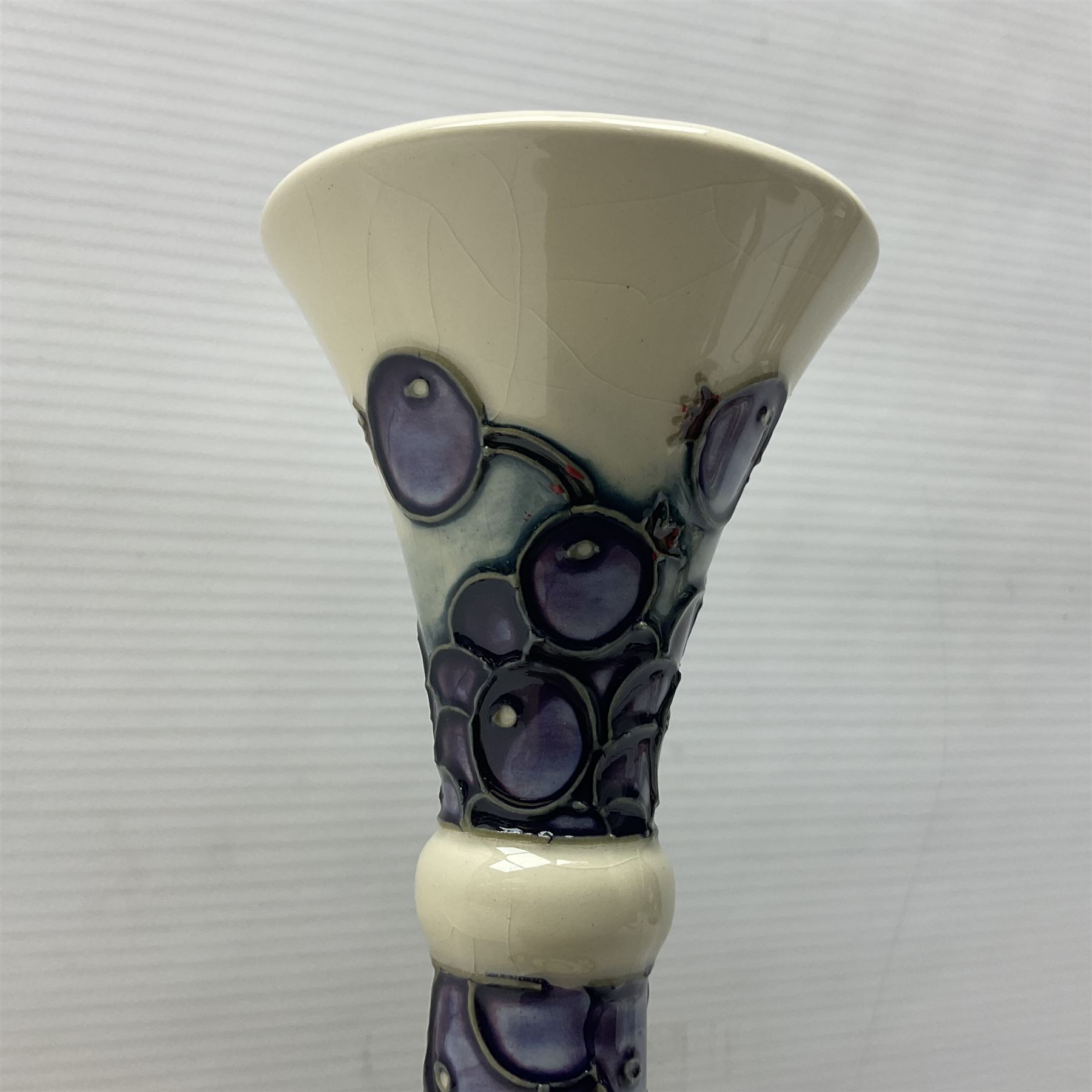 Moorcroft vase, of compressed form with a tall flared neck, decorated in the Juneberry pattern, circa 2000, H25cm