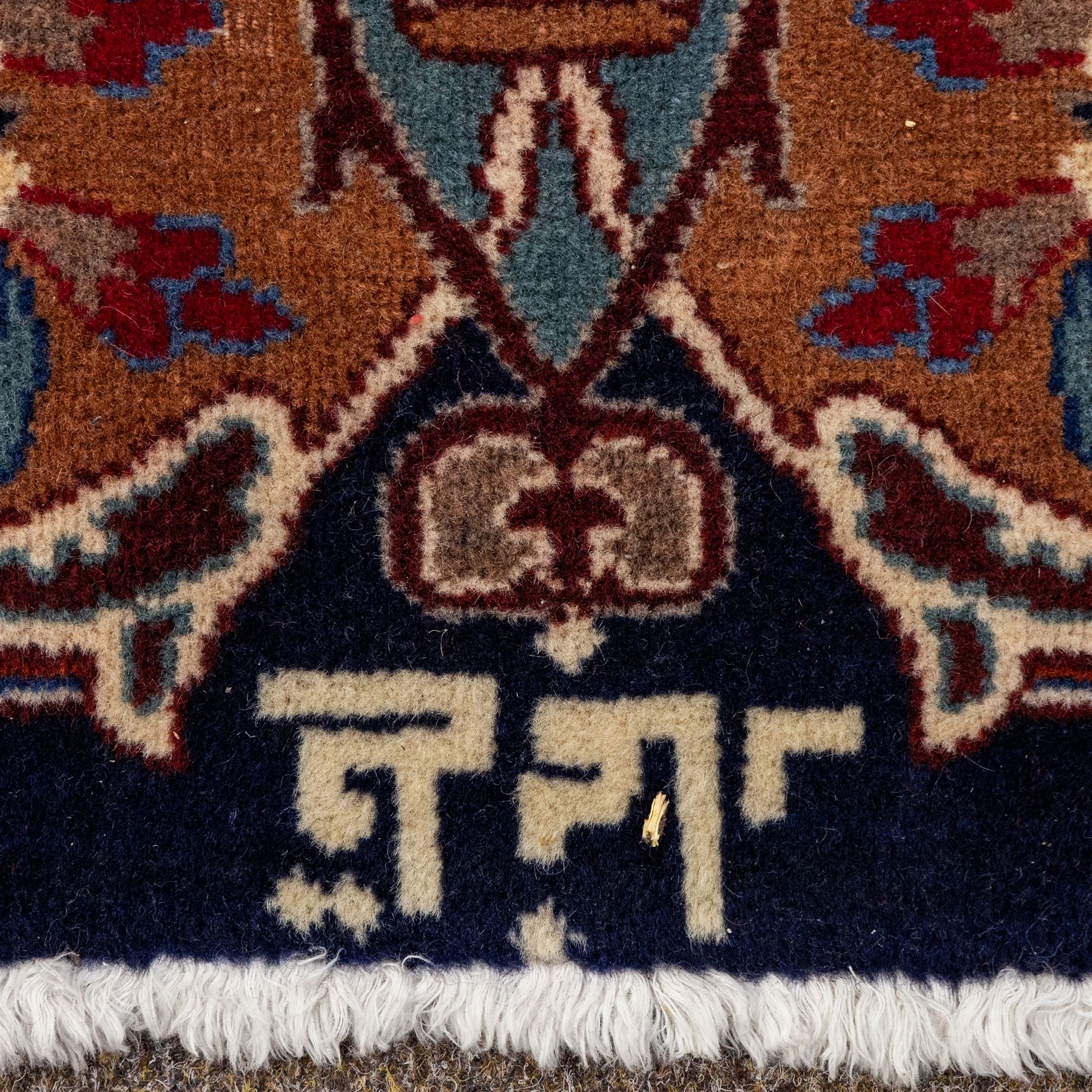 North East Persian Meshed hand-knotted carpet, deep navy field with central complex medallion and densely decorated scrolling floral sprays and palmettes, incorporating cartouche motifs enclosed by a broad tan and dark blue border ornamented by stylized vases flanked by multiple guard stripes, signed 'Amal-e Haji translates as the Work of Haji', with cotton fringe ends 