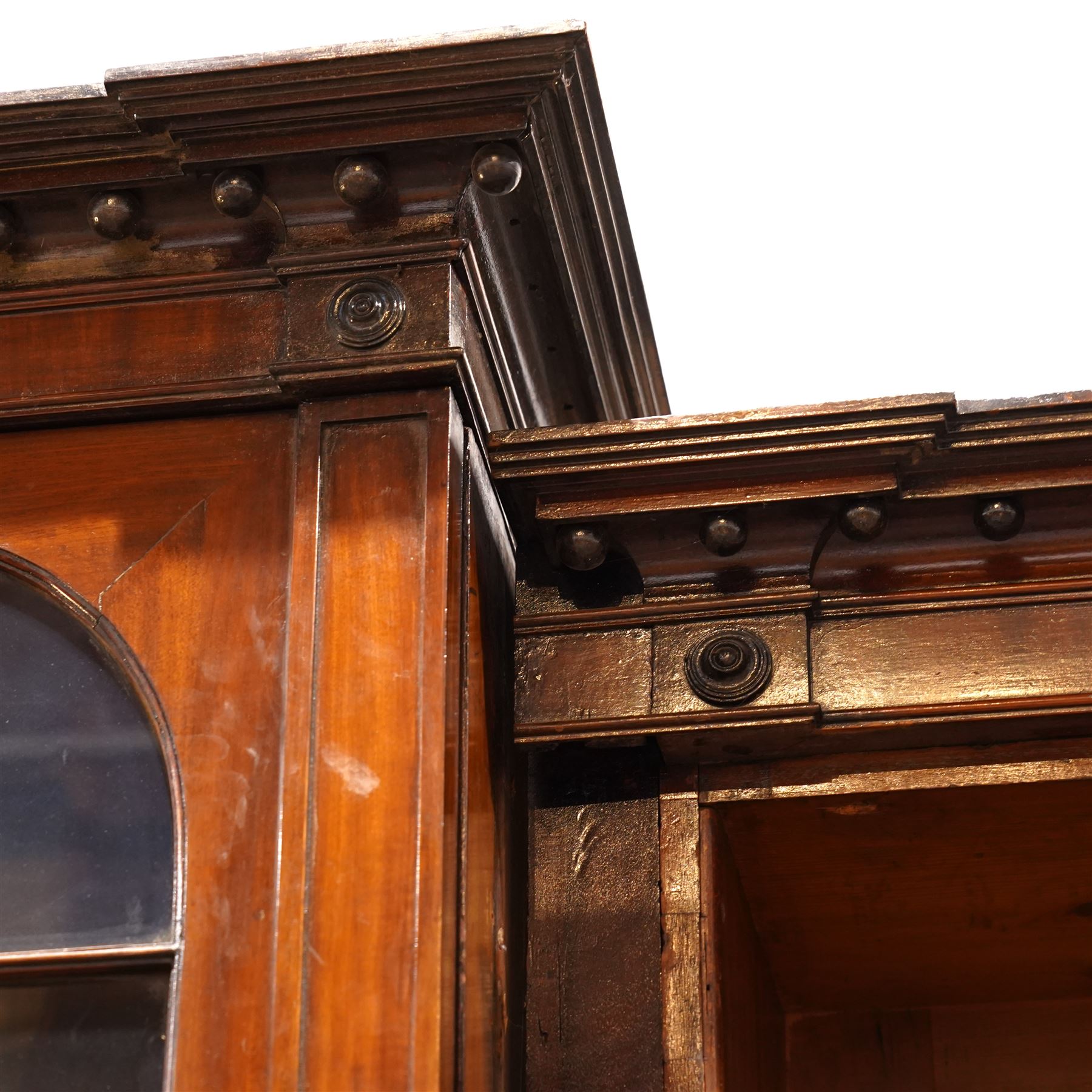 Large Georgian mahogany library bookcase, projecting moulded cornice with row of globular mounts, adjustable shelving enclosed by six astragal glazed doors, fitted with two slides and six panelled cupboard doors, two banks of five drawers, on moulded plinth base; together with two pairs of associated astragal glazed doors in mahogany, from the same property (W55.5cm x H168cm & W48cm x 168cm)