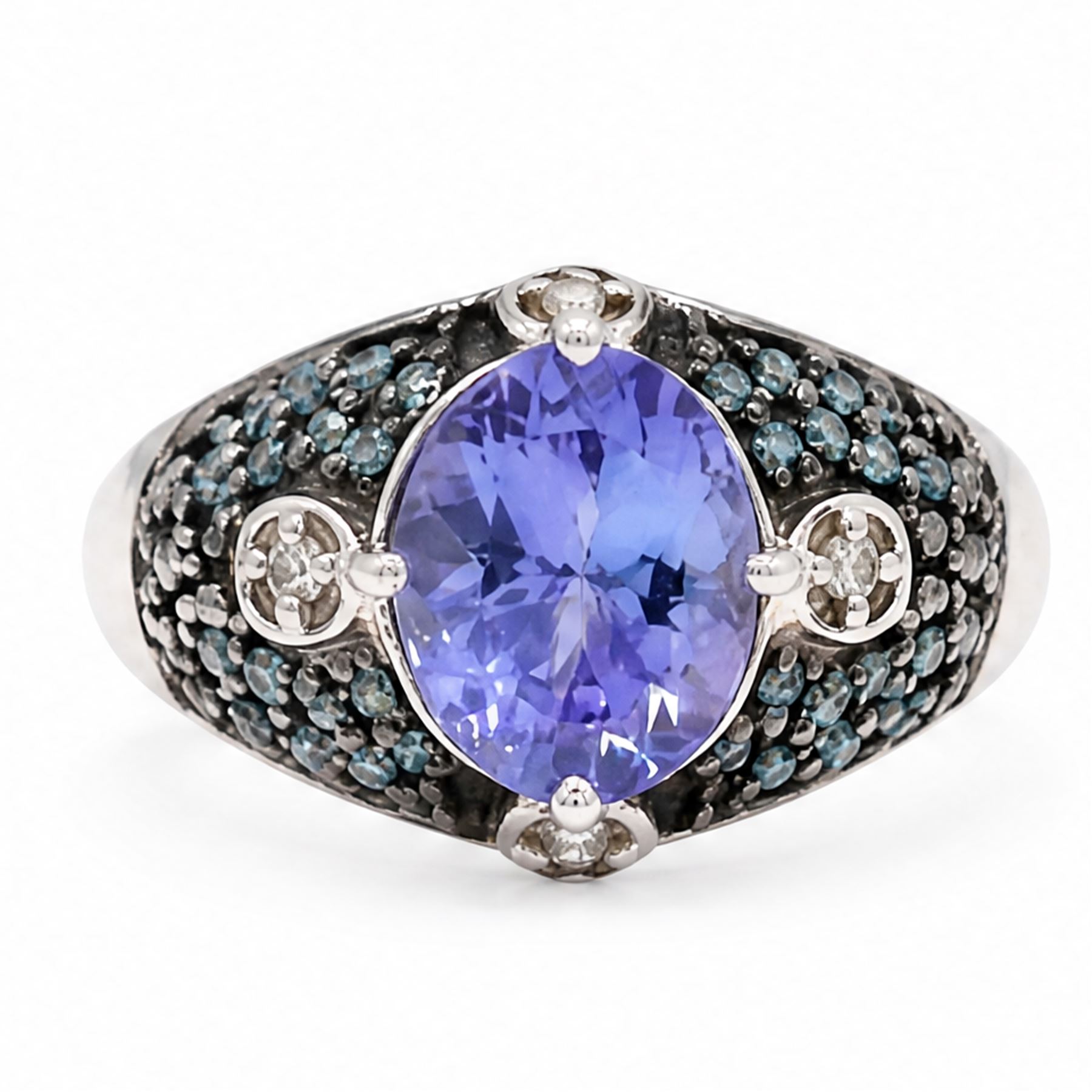 9ct white gold tanzanite and diamond ring, single oval cut tanzanite of approx 1.70 carat, surrounded by four single cut white diamonds and pave set blue diamonds, hallmarked