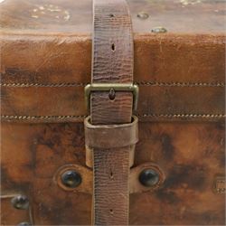 19th century leather trunk, featuring brass lock, with leather anchoring straps around the body, with leather handles