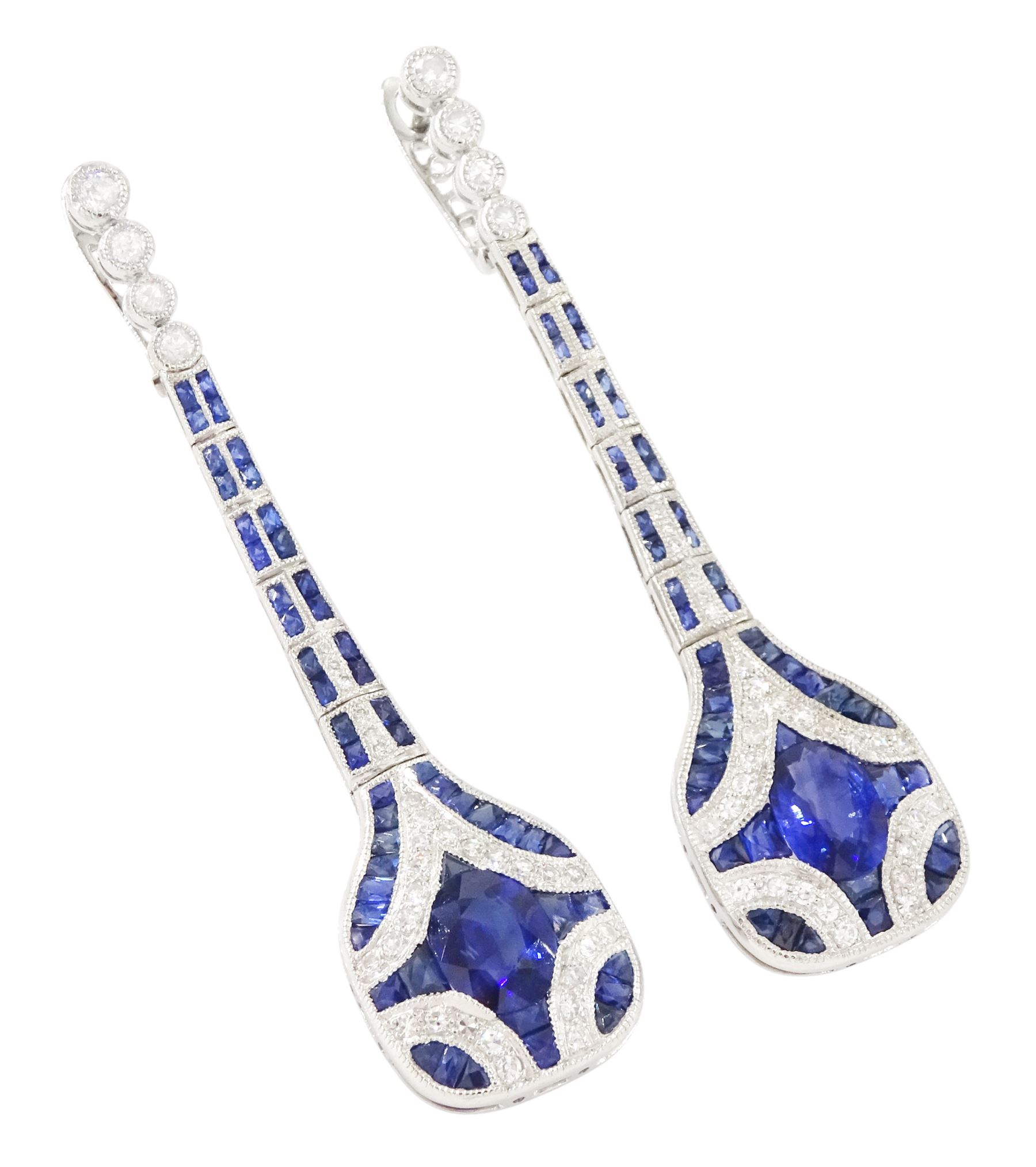 Pair of platinum sapphire and diamond pendant earrings, each stud milgrain set with a single oval cut sapphire, surrounded by calibre cut sapphires and single cut diamonds, suspending from six graduating articulated panels, to four single cut diamonds, total sapphire weight approx 3.80 carat, total diamond weight approx 0.80 carat